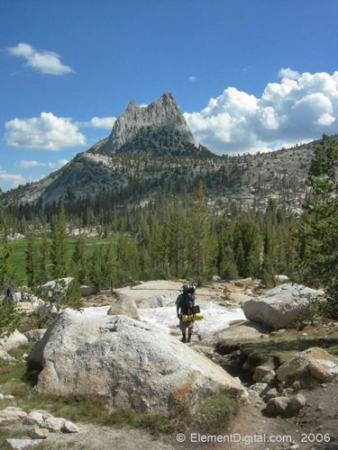 Hiker descends into a meadow